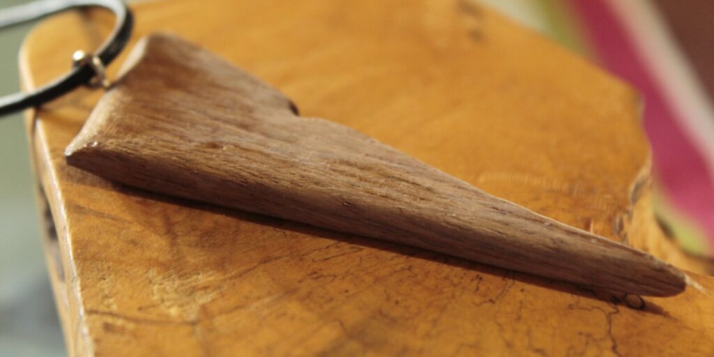 Pendentif triangle en bois massif, sur cordon noir